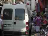 photo of Van squeezing through crowd